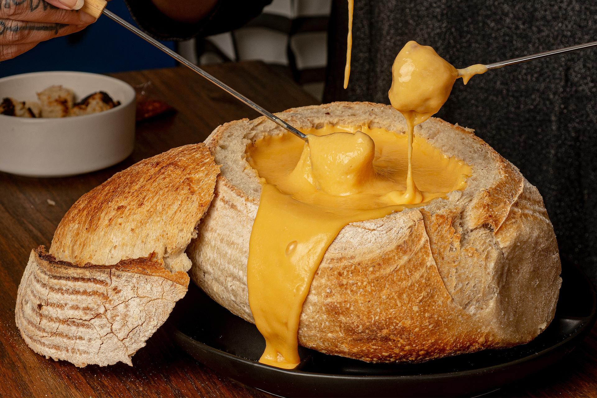 People eating fondue and bread on holiday