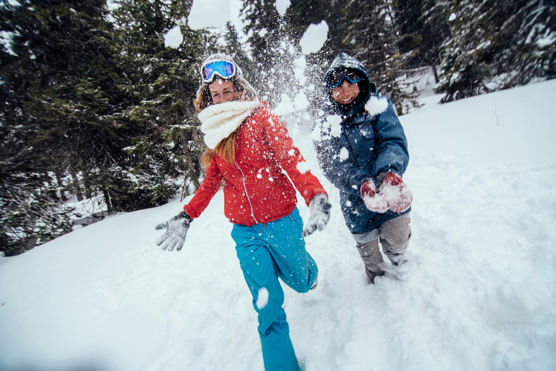 Couple having fun in the snow at ski resort