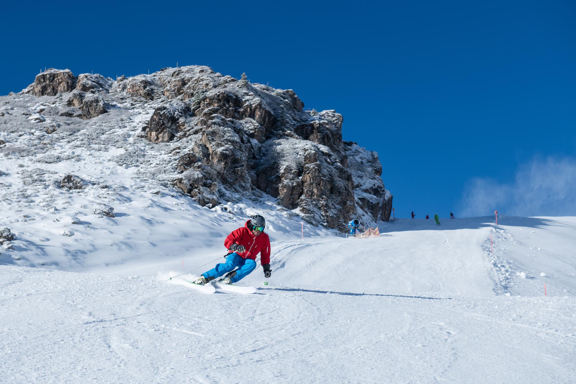 skier carving down kitzski ski area slope on an Austria ski holiday
