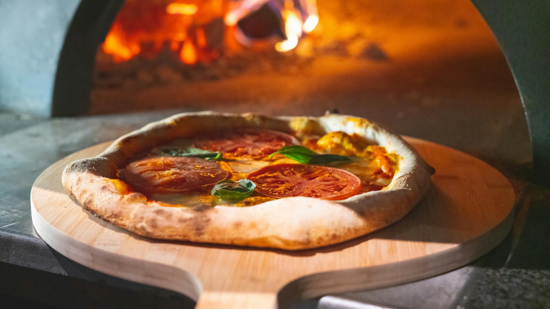 pizza-coming-out-of-a-pizza-oven